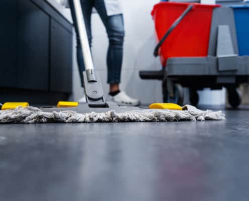 Close up of a janitor's mop cleaning the floor