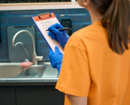 Worker looking over cleaning checklist