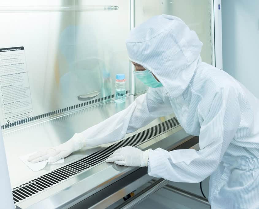 person cleaning clean room desk