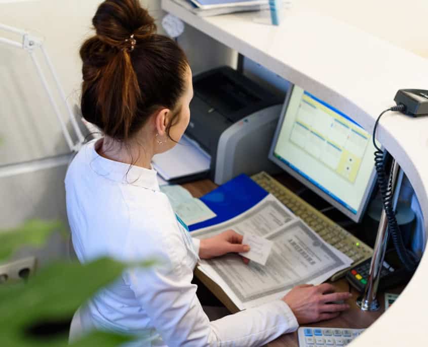 Person at front desk of dental office