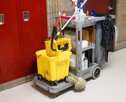 cleaning cart and supplies infront of school lockers